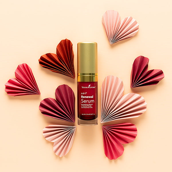Bottle of Renewal Serum surrounded by paper hearts