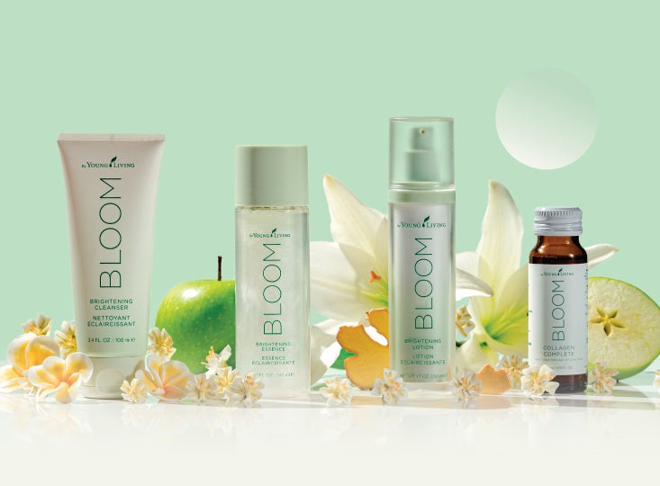 Bottle of Bloom Brightening Cleanser with flowers and plant background